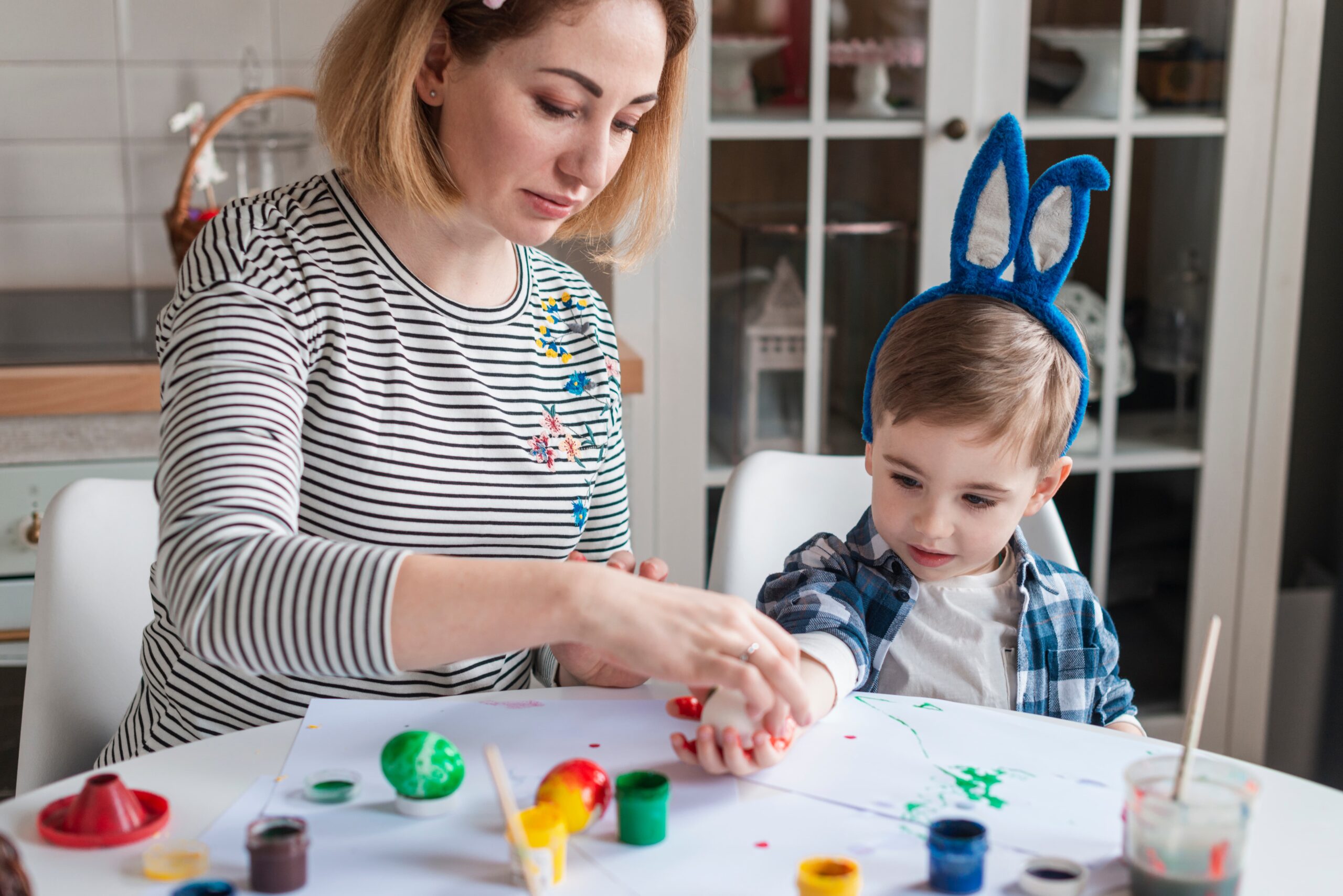 beautiful mother teaching little boy how paint eggs 1 scaled