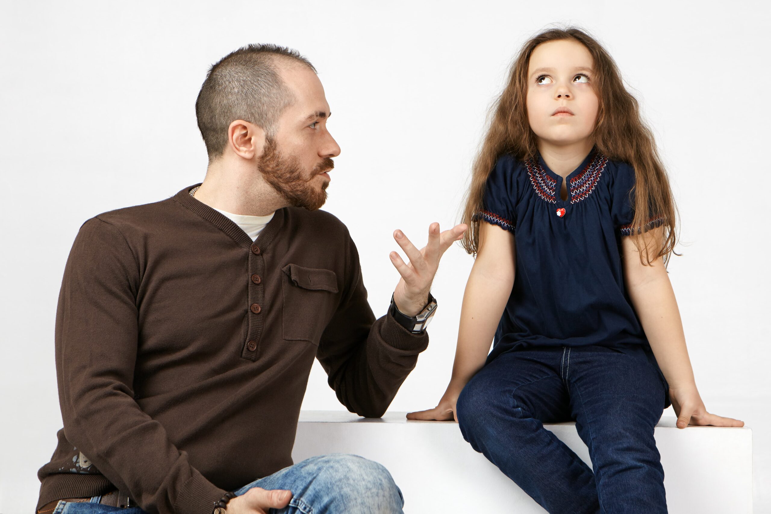 horizontal portrait fashionable young bearded male having serious conversation with his naughty spoiled female child talking about rules her 1 scaled