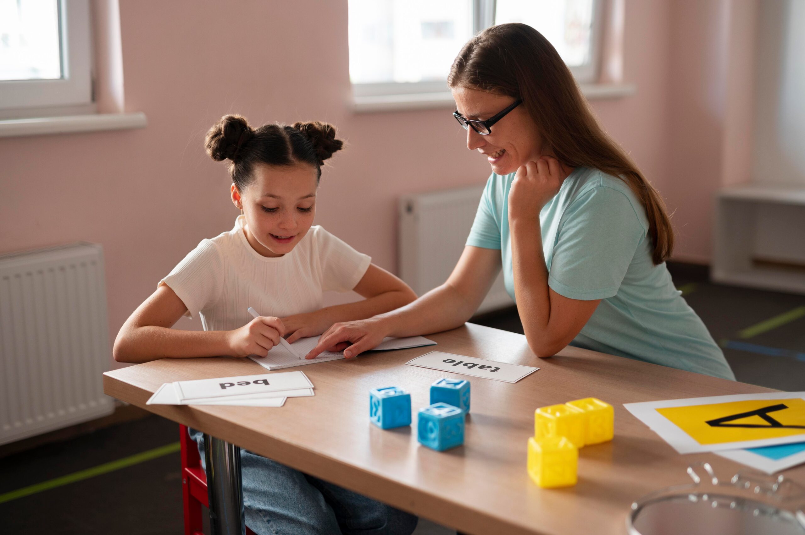 psychologist helping little girl speech therapy indoors 1 scaled